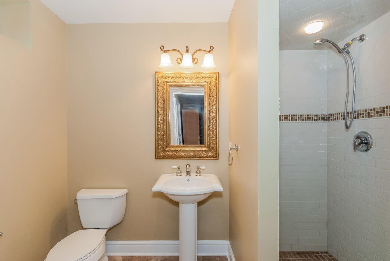 44 Gower Road New Canaan, CT 06840 - Photo 49 of 53 a bathroom with a sink mirror toilet and a shower