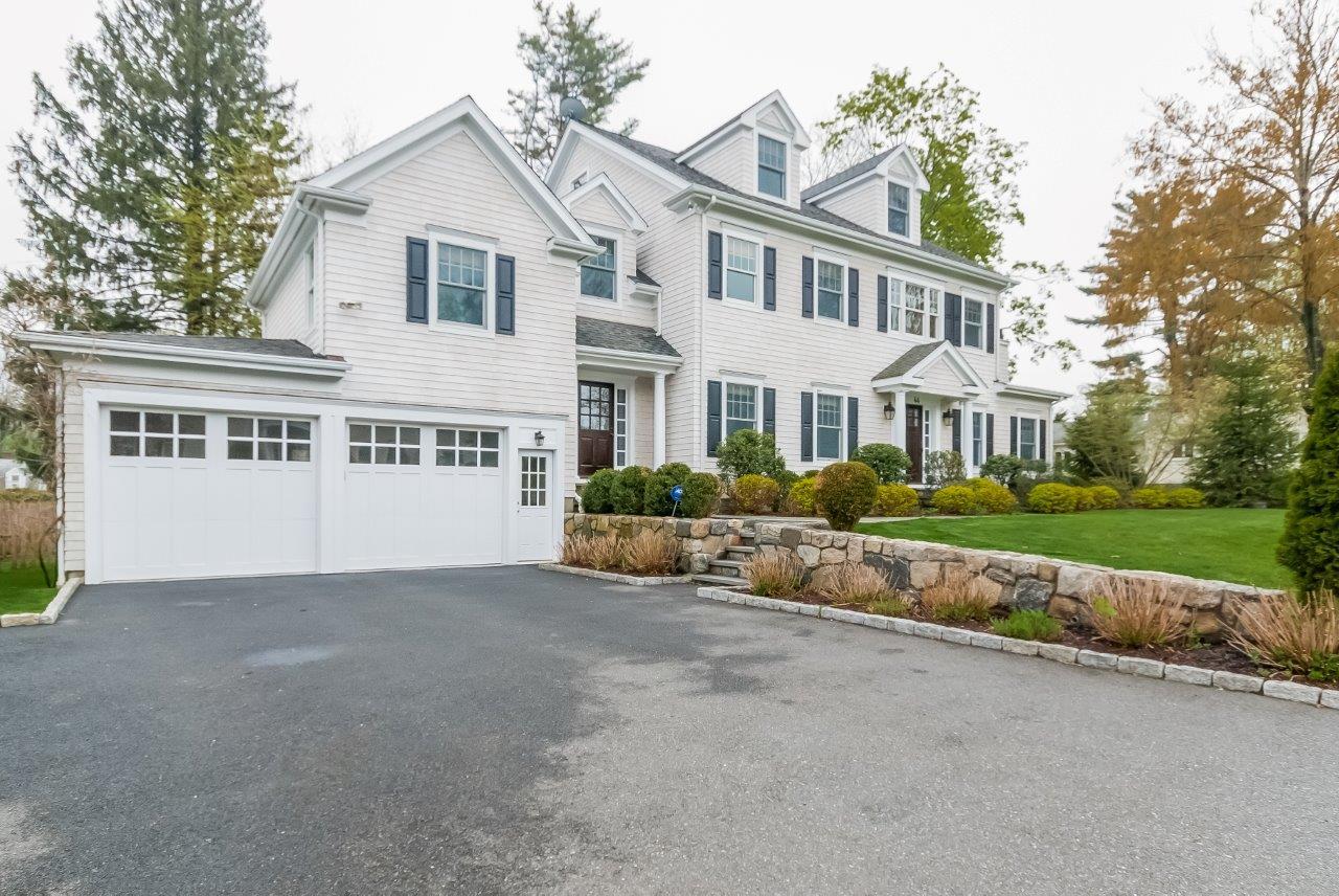 44 Gower Road New Canaan, CT 06840 - Photo 5 of 53 a view of a white house with a big yard and large trees