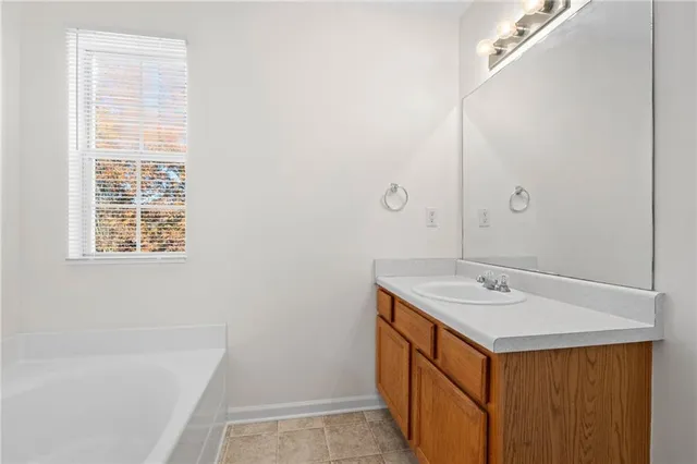 a bathroom with a sink a vanity and a bathtub