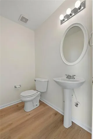 a bathroom with a sink a mirror and toilet