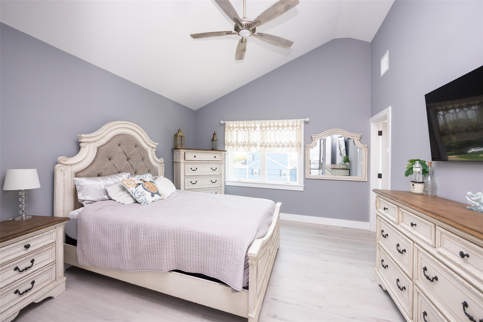 390 East Shore Road Lindenhurst, NY 11757 - Photo 12 of 27 Bedroom with light wood-style flooring, high vaulted ceiling, and a ceiling fan