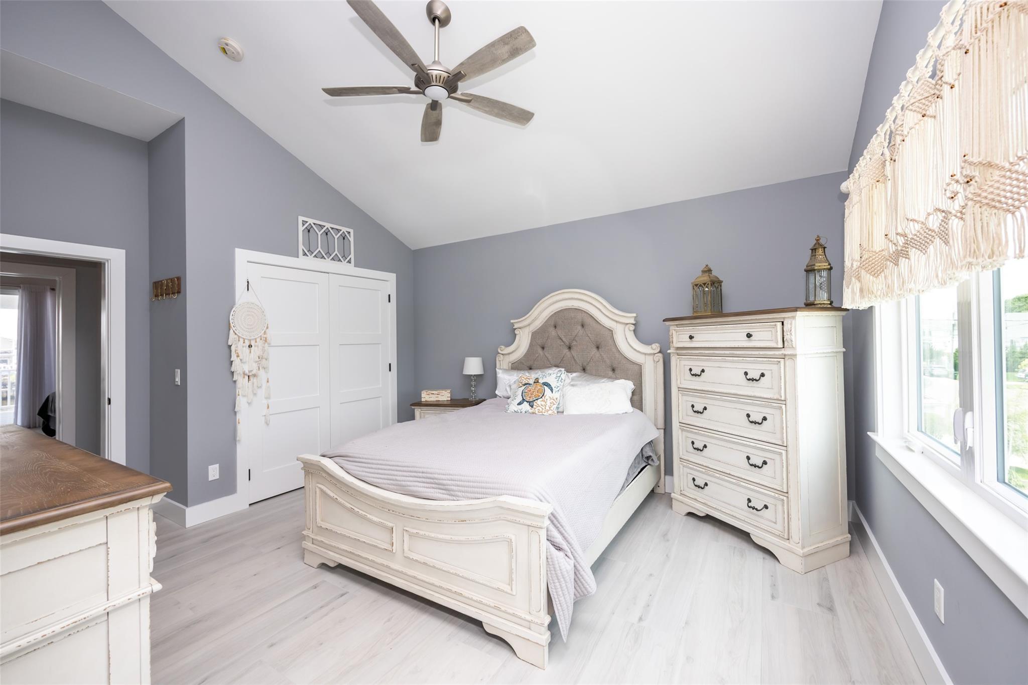 390 East Shore Road Lindenhurst, NY 11757 - Photo 13 of 27 Bedroom with lofted ceiling, light wood-type flooring, a closet, and ceiling fan