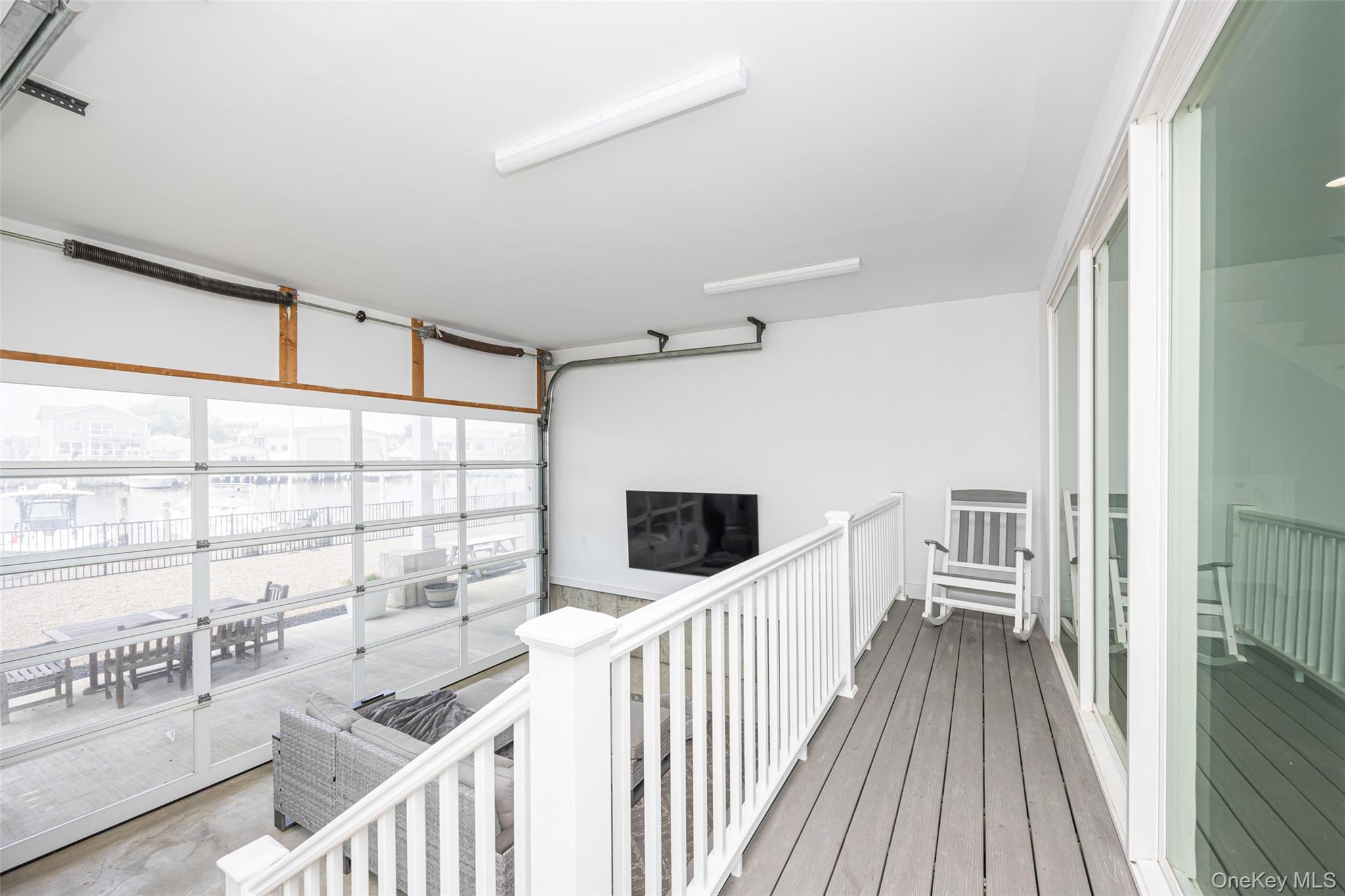 390 East Shore Road Lindenhurst, NY 11757 - Photo 16 of 27 a view of a hallway with wooden floor and windows