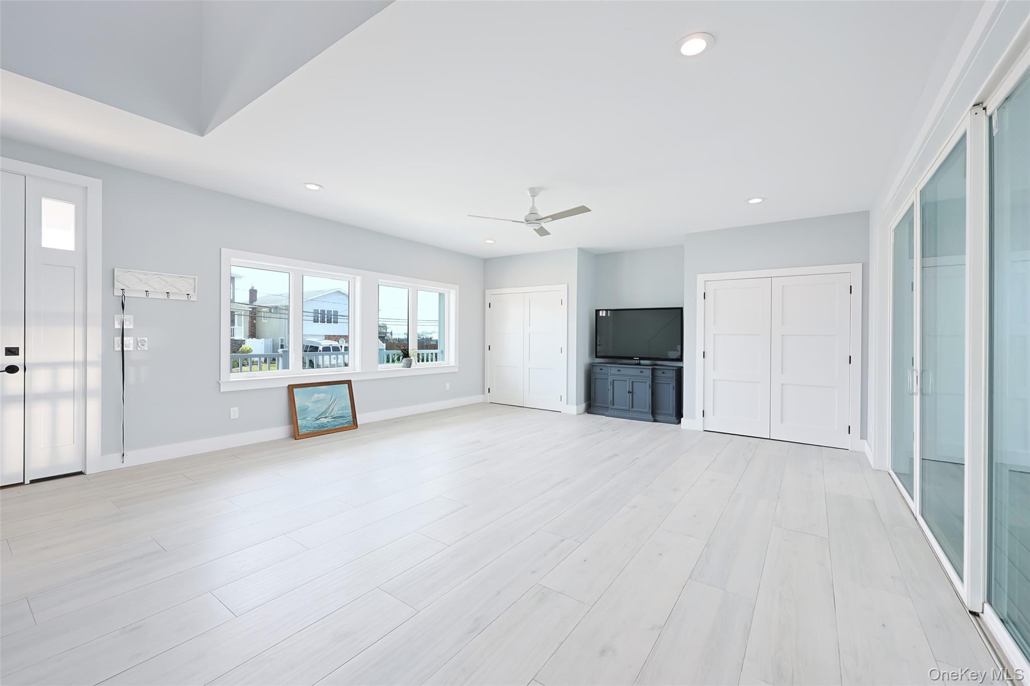 390 East Shore Road Lindenhurst, NY 11757 - Photo 17 of 27 an empty room with large window and fireplace