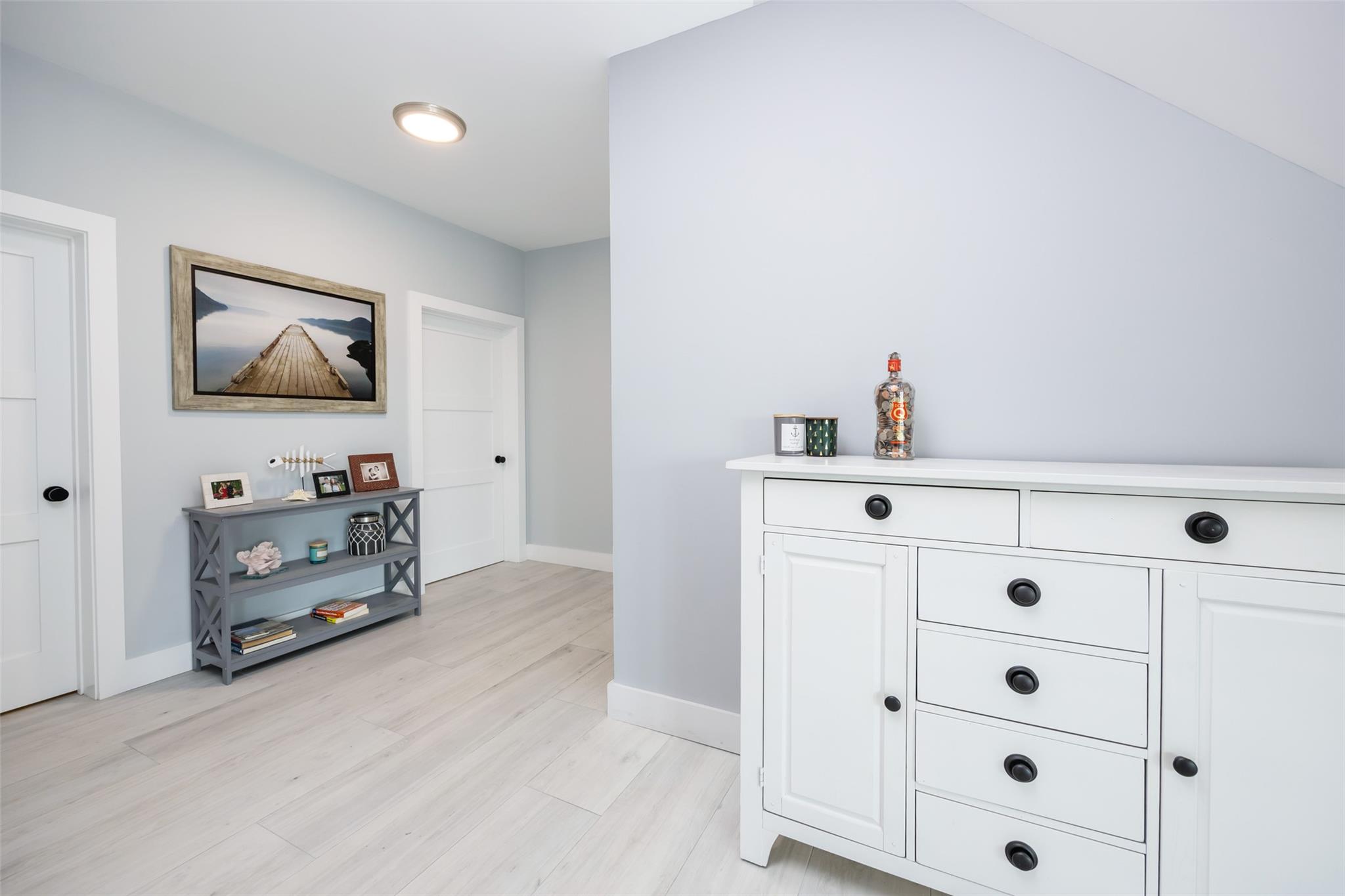 390 East Shore Road Lindenhurst, NY 11757 - Photo 18 of 27 Hallway with baseboards and light wood finished floors