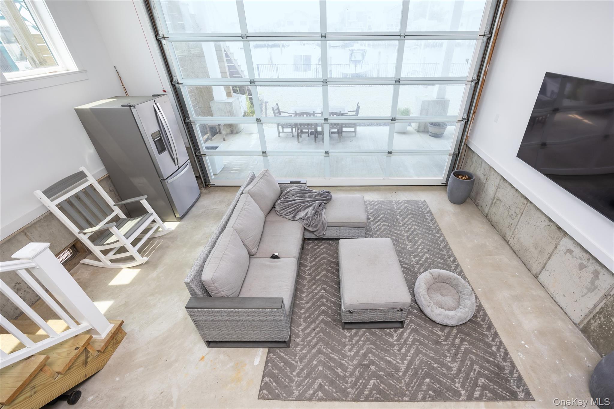 390 East Shore Road Lindenhurst, NY 11757 - Photo 19 of 27 a living room with furniture and a floor to ceiling window