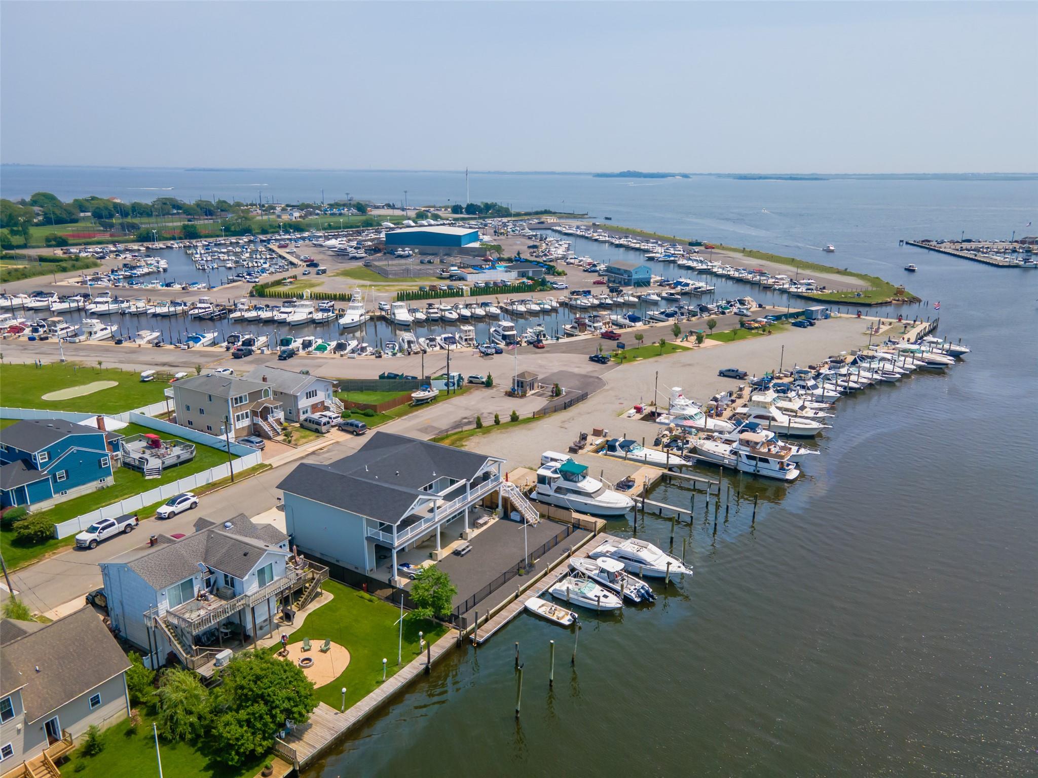 390 East Shore Road Lindenhurst, NY 11757 - Photo 2 of 27 Drone / aerial view of numerous boat docks and a nearby body of water