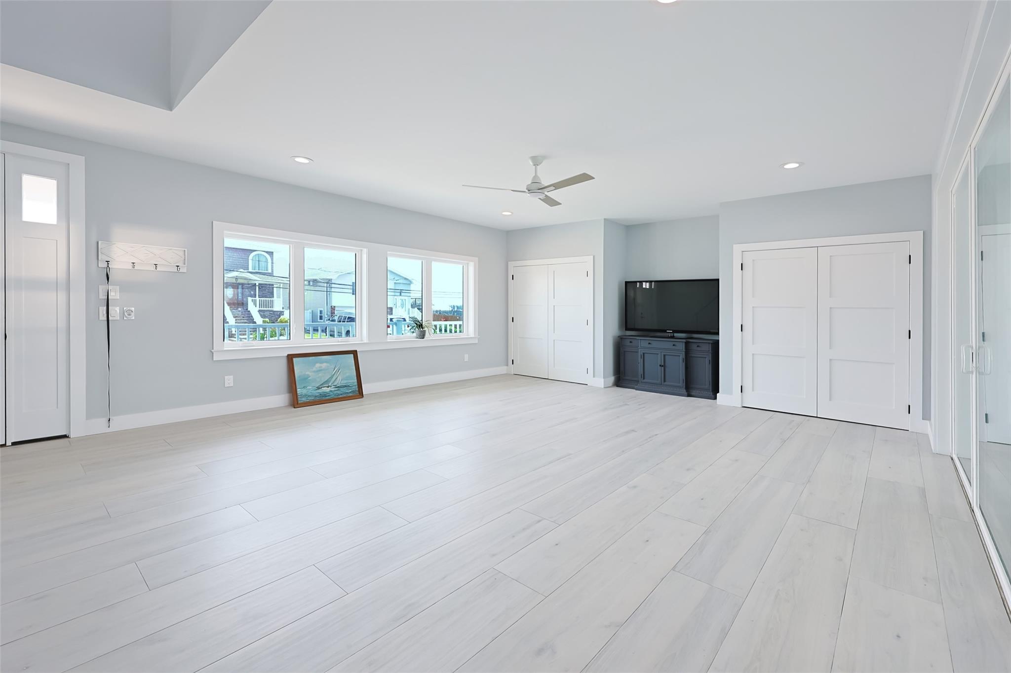 390 East Shore Road Lindenhurst, NY 11757 - Photo 27 of 27 Unfurnished living room featuring a ceiling fan, recessed lighting, and light wood finished floors
