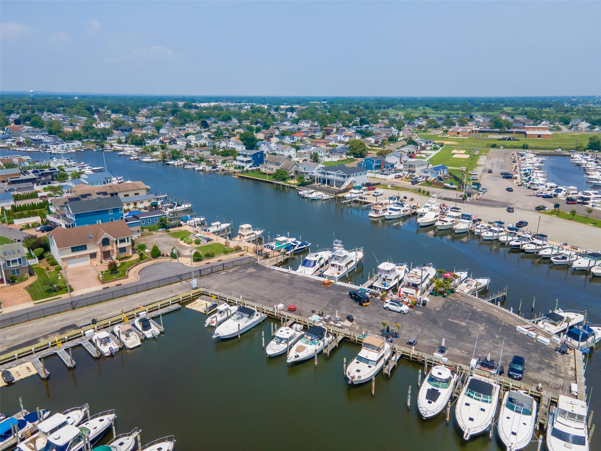 390 East Shore Road Lindenhurst, NY 11757 - Photo 3 of 27 Bird's eye view of numerous boat docks and a nearby body of water