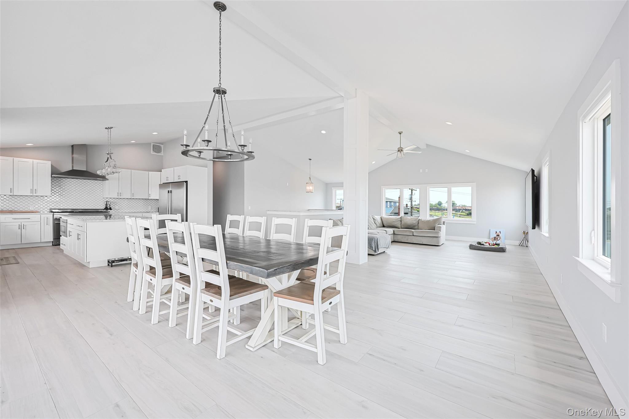 390 East Shore Road Lindenhurst, NY 11757 - Photo 4 of 27 a view of a dining room and livingroom with furniture wooden floor kitchen view and a chandelier