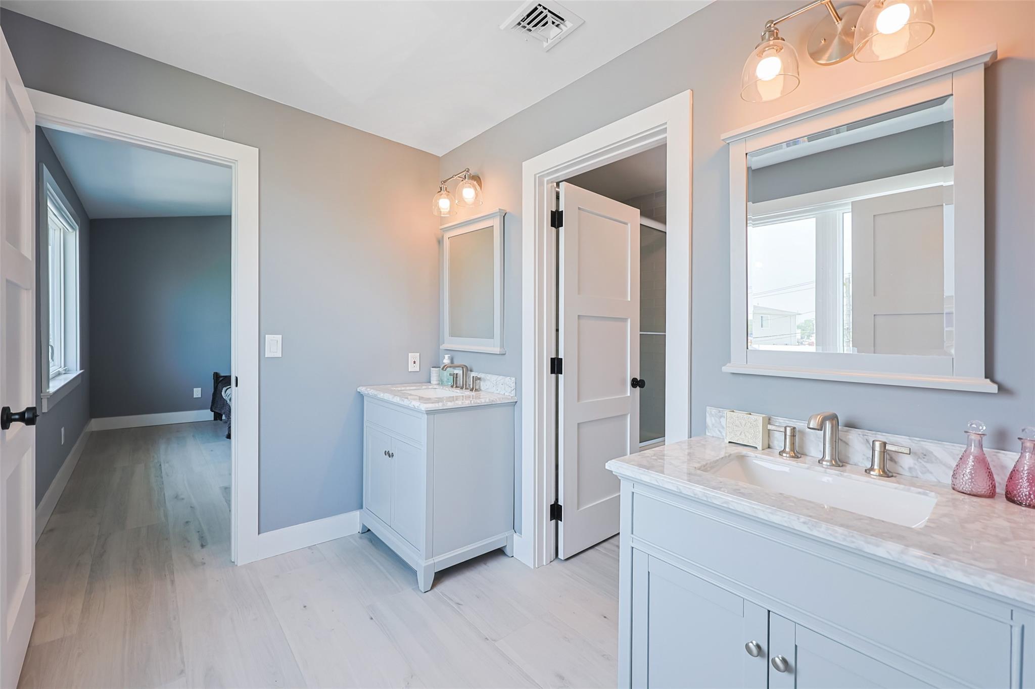 390 East Shore Road Lindenhurst, NY 11757 - Photo 5 of 27 Full bathroom featuring wood finished floors and two vanities