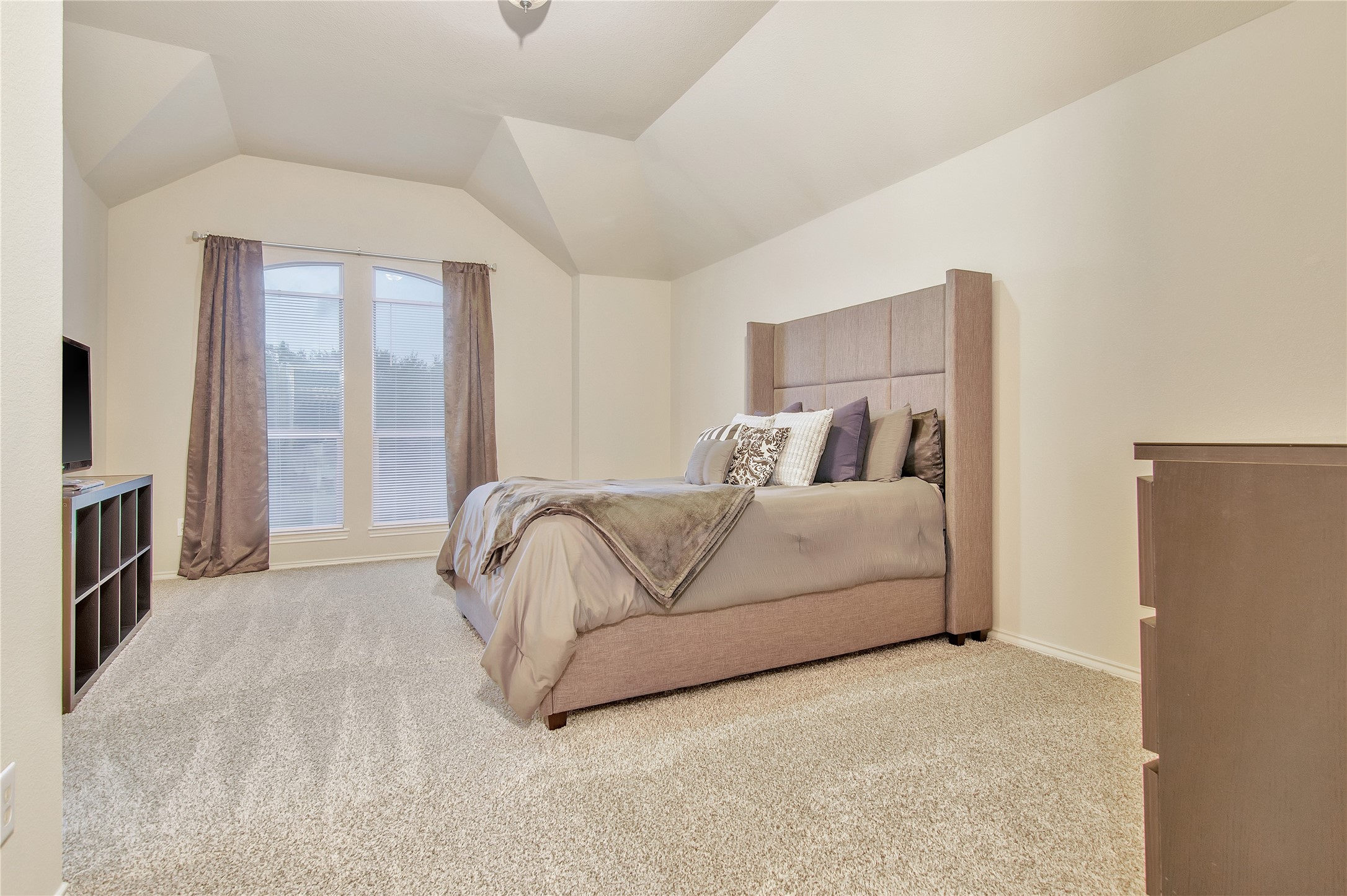 16518 Strathmore Manor Lane Houston, TX 77090 - Photo 13 of 25 a bedroom with a bed and a flat screen tv