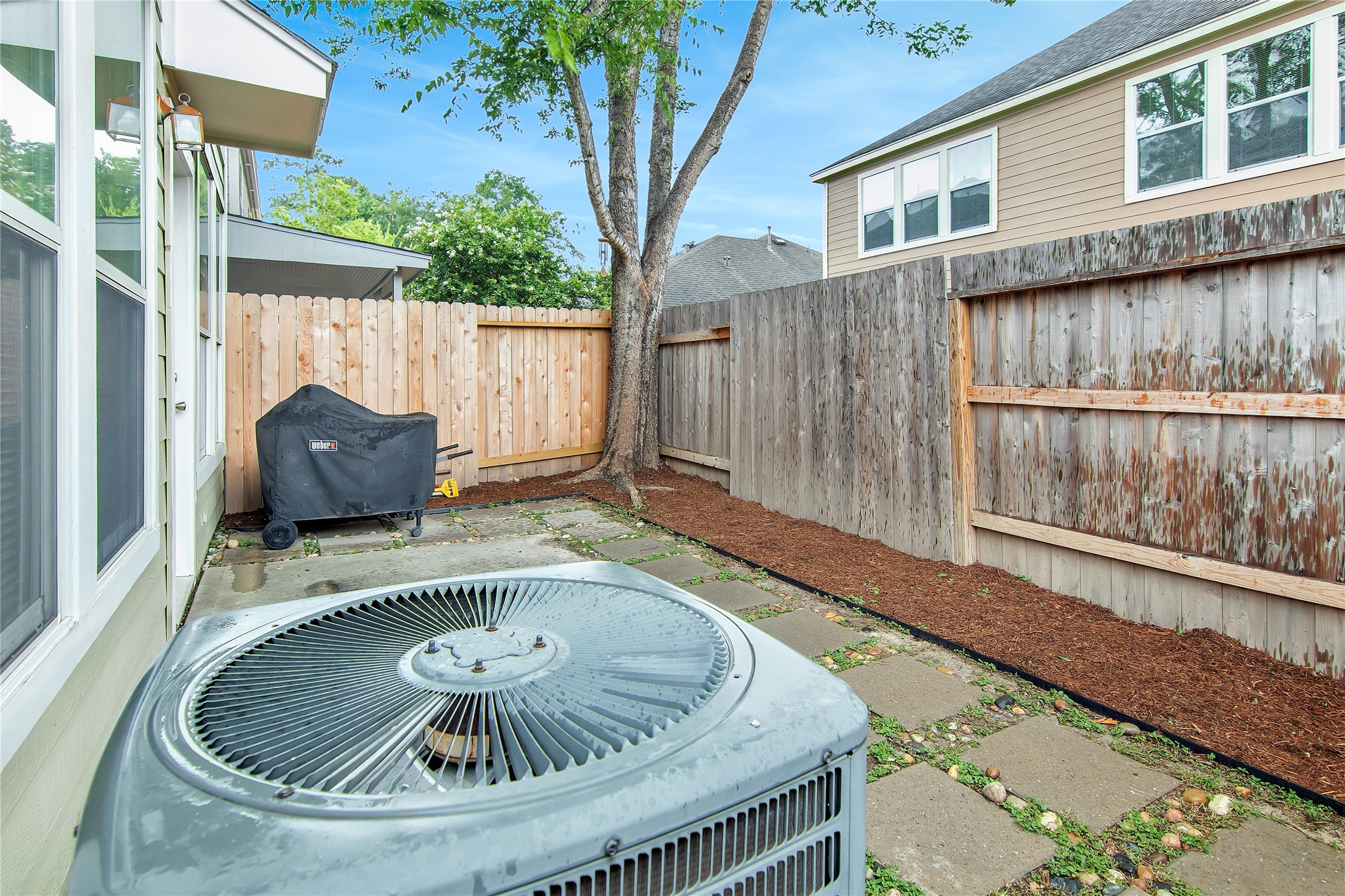 16518 Strathmore Manor Lane Houston, TX 77090 - Photo 24 of 25 a wooden table sitting in front of a house