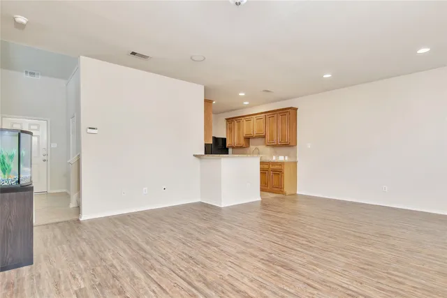 a view of a kitchen with wooden floor