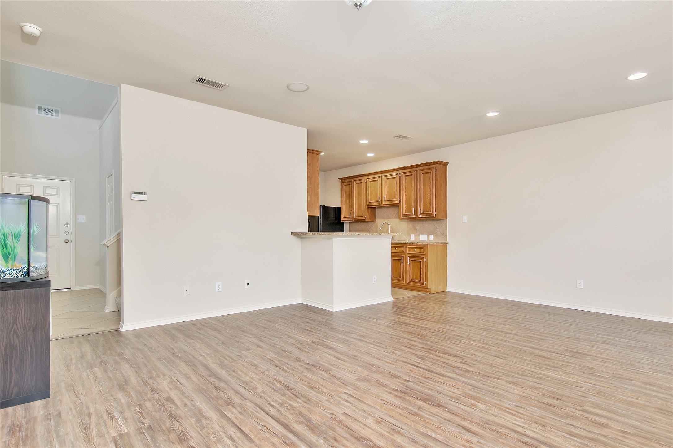 16518 Strathmore Manor Lane Houston, TX 77090 - Photo 6 of 25 a view of a kitchen with wooden floor