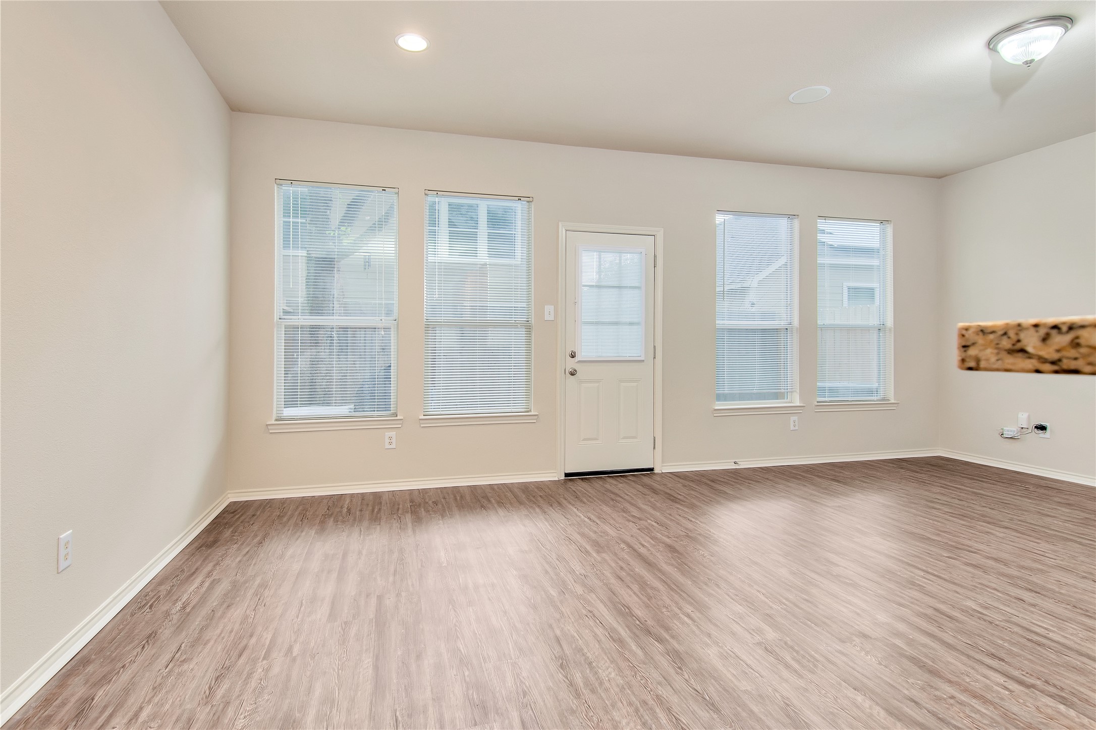 16518 Strathmore Manor Lane Houston, TX 77090 - Photo 8 of 25 an empty room with wooden floor and windows