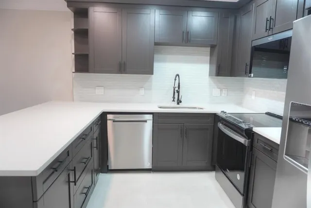 a kitchen with a sink and cabinets