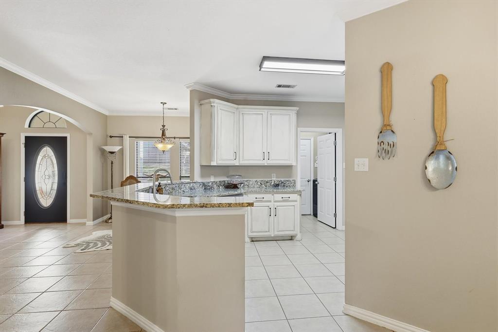 1805 Spinnaker Lane Azle, TX 76020 - Photo 14 of 40 a kitchen with a sink a refrigerator and cabinets