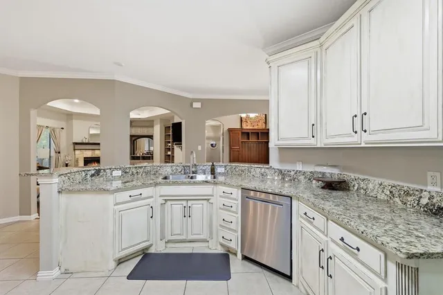 a kitchen with stainless steel appliances granite countertop a sink and cabinets