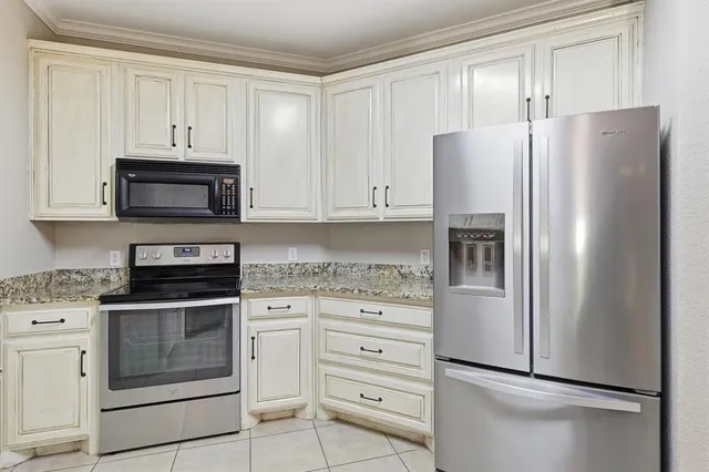 a kitchen with cabinets stainless steel appliances and a counter space