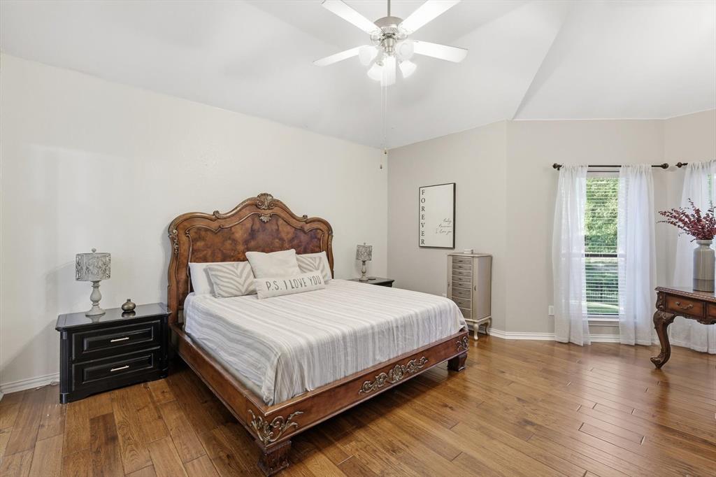 1805 Spinnaker Lane Azle, TX 76020 - Photo 20 of 40 a bedroom with a bed and wooden floor