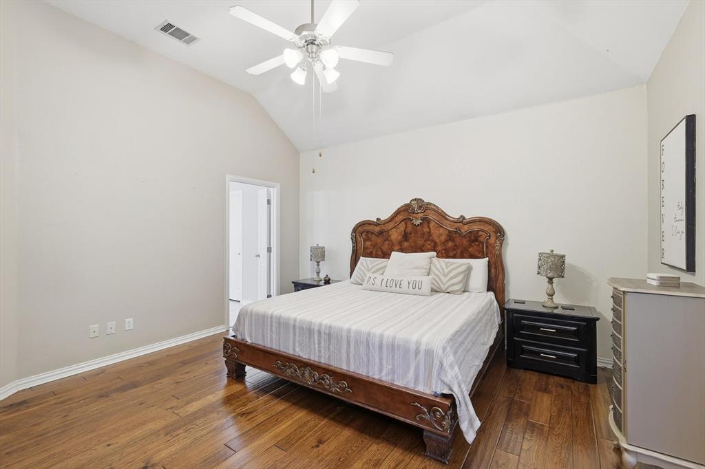 1805 Spinnaker Lane Azle, TX 76020 - Photo 21 of 40 a bedroom with a bed and wooden floor