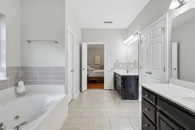 a view of walk in closet with clothes