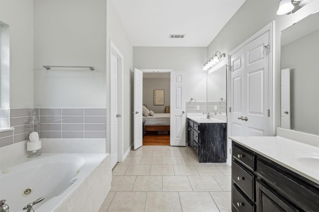 1805 Spinnaker Lane Azle, TX 76020 - Photo 25 of 40 a large en suite bathroom with a tub sink and mirror