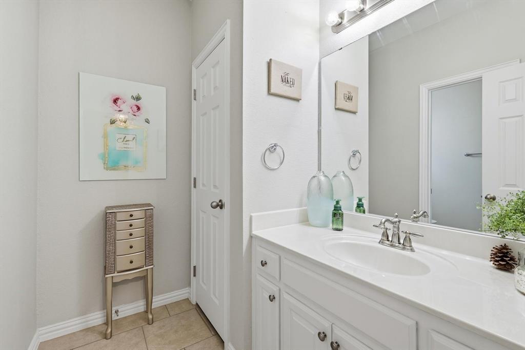 1805 Spinnaker Lane Azle, TX 76020 - Photo 28 of 40 a bathroom with a granite countertop sink and a mirror