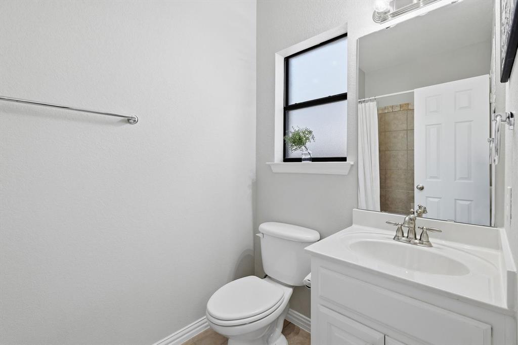 1805 Spinnaker Lane Azle, TX 76020 - Photo 29 of 40 a bathroom with a sink toilet and vanity