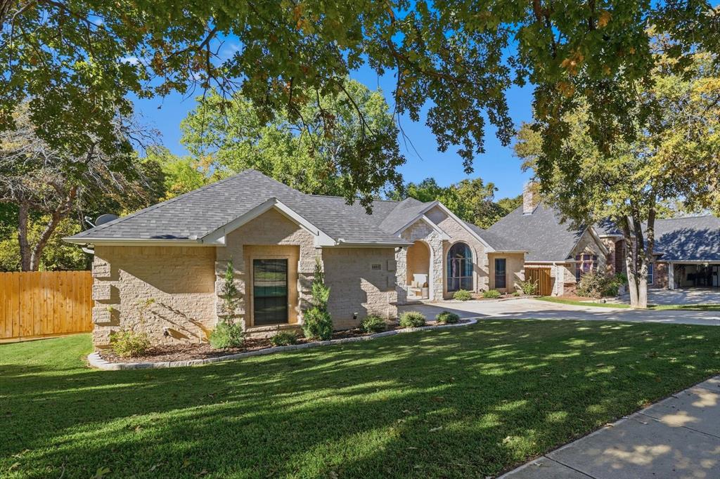 1805 Spinnaker Lane Azle, TX 76020 - Photo 3 of 40 a front view of a house with a garden