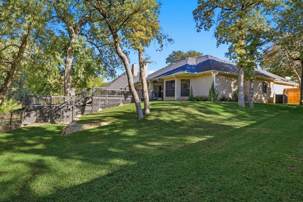 1805 Spinnaker Lane Azle, TX 76020 - Photo 35 of 40 a front view of a house with a garden