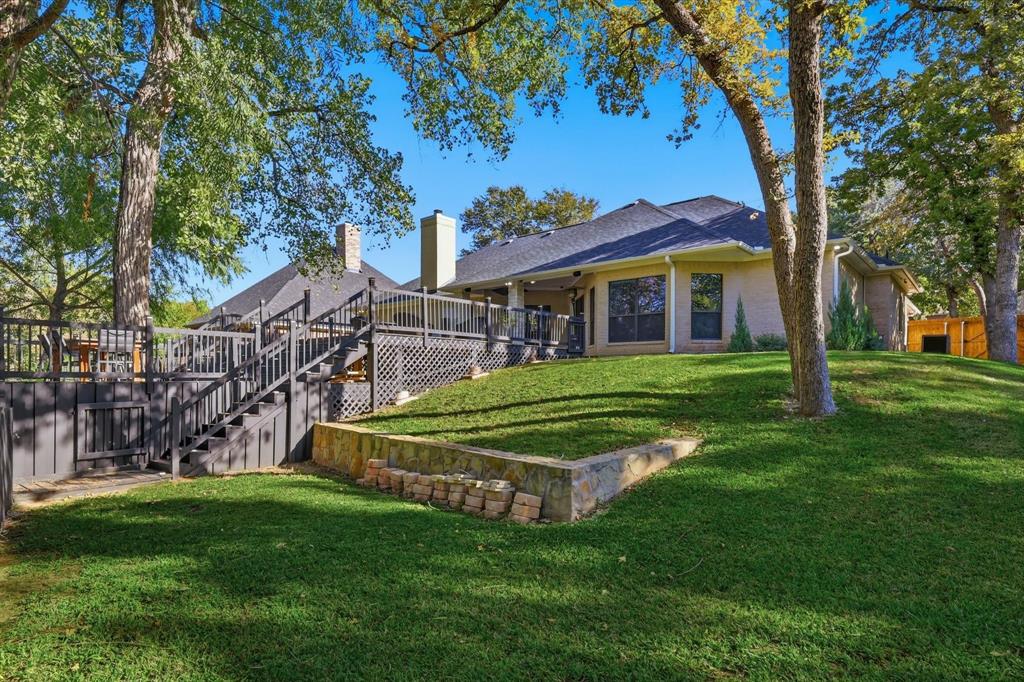 1805 Spinnaker Lane Azle, TX 76020 - Photo 36 of 40 a view of a house with a big yard and large trees