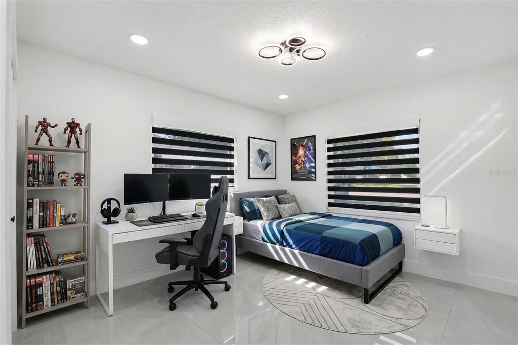 3216 West Beach Street Tampa, FL 33607 - Photo 19 of 63 a bedroom with a bed and a book shelf