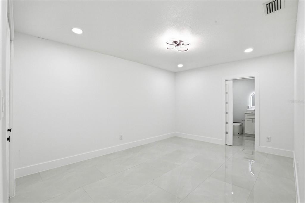3216 West Beach Street Tampa, FL 33607 - Photo 25 of 63 an empty room with a bathroom and a hallway