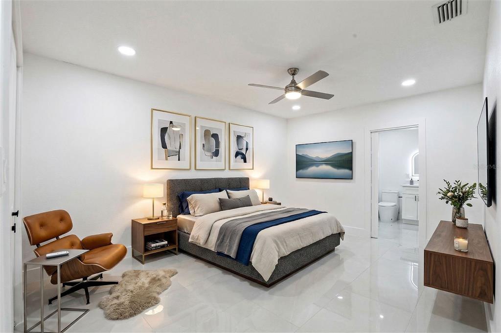 3216 West Beach Street Tampa, FL 33607 - Photo 26 of 63 a spacious bedroom with a bed a couch and potted plant