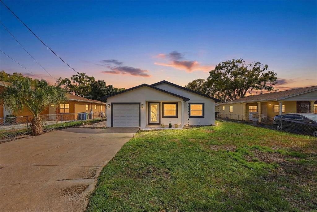 3216 West Beach Street Tampa, FL 33607 - Photo 3 of 63 a front view of a house with a yard