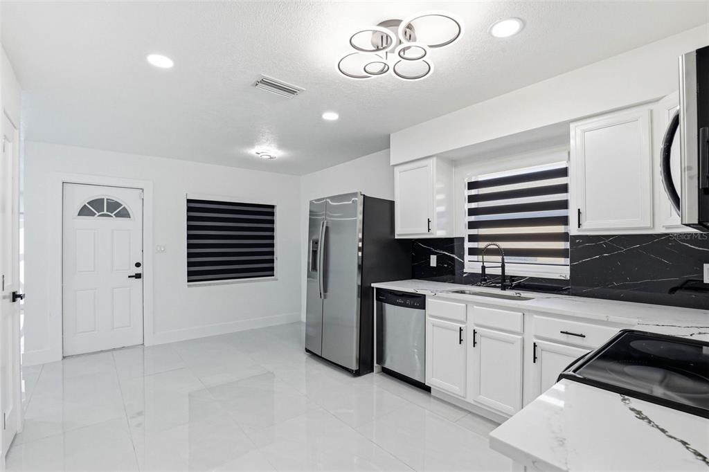 3216 West Beach Street Tampa, FL 33607 - Photo 42 of 63 a kitchen with stainless steel appliances a refrigerator and a stove top oven