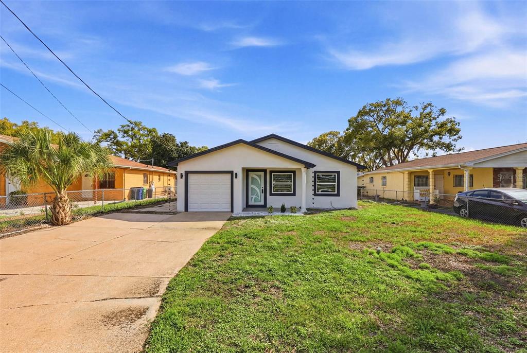 3216 West Beach Street Tampa, FL 33607 - Photo 60 of 63 a front view of a house with a yard
