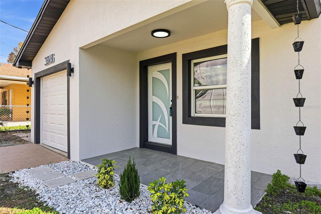 3216 West Beach Street Tampa, FL 33607 - Photo 10 of 63 a front view of a house with a yard