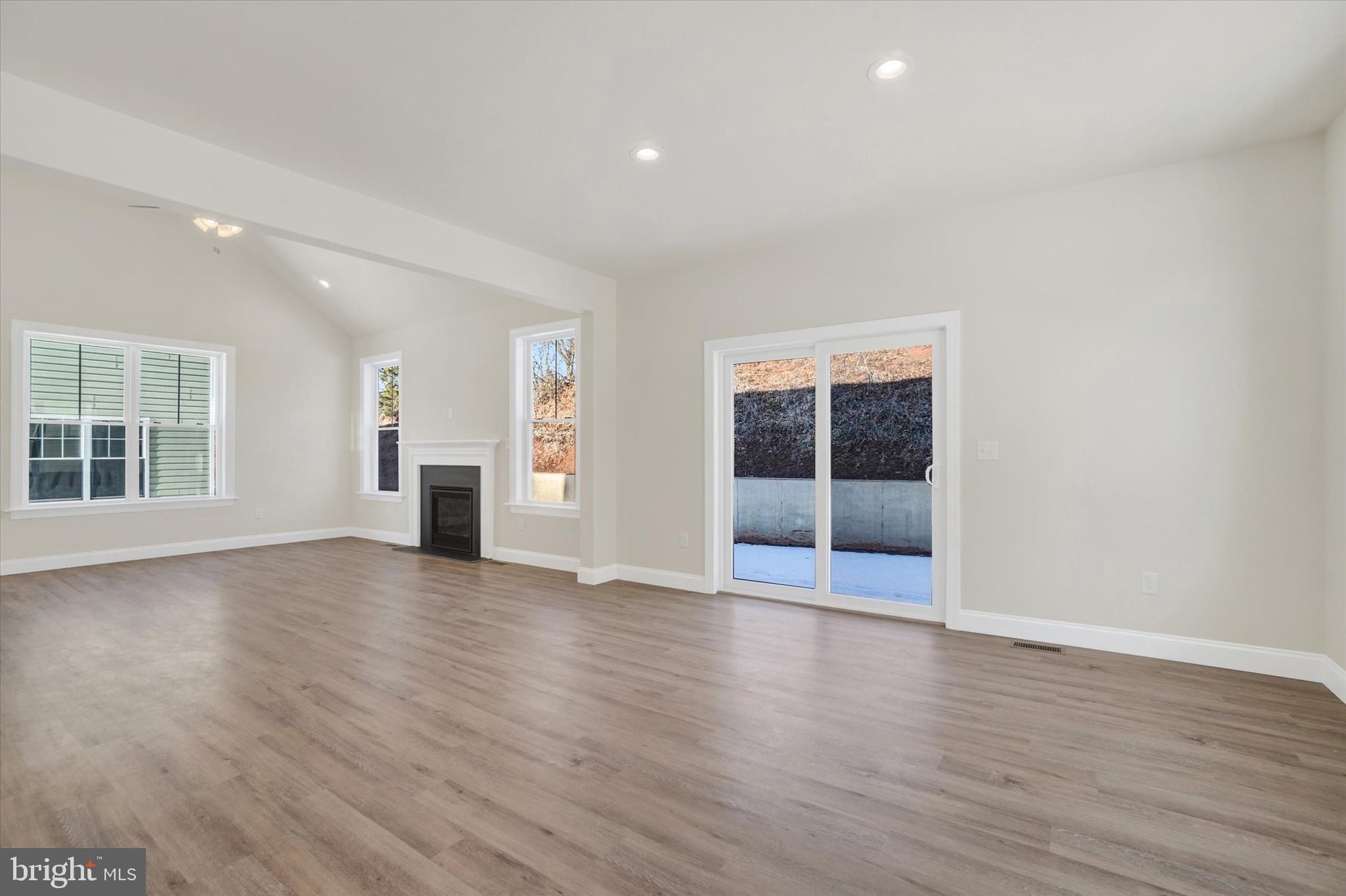 145 Eli Drive York, PA 17404 - Photo 12 of 20 a view of an empty room with wooden floor and a window