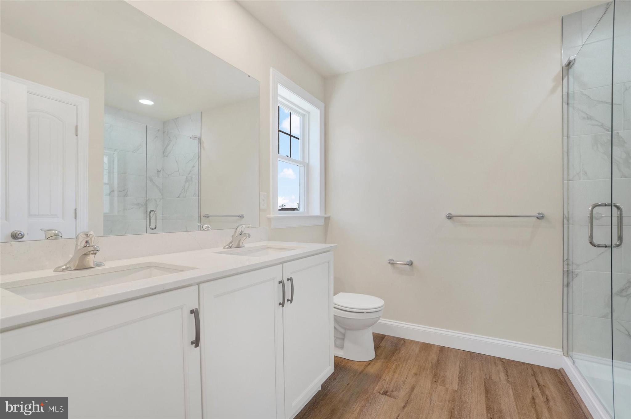 145 Eli Drive York, PA 17404 - Photo 15 of 20 a bathroom with a granite countertop sink a toilet and a mirror