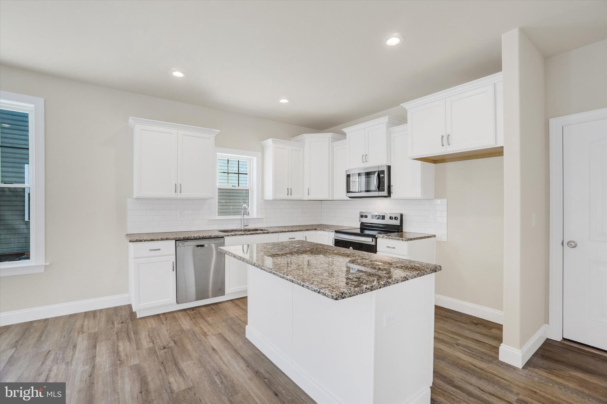 145 Eli Drive York, PA 17404 - Photo 3 of 20 a kitchen with granite countertop a sink stove and refrigerator