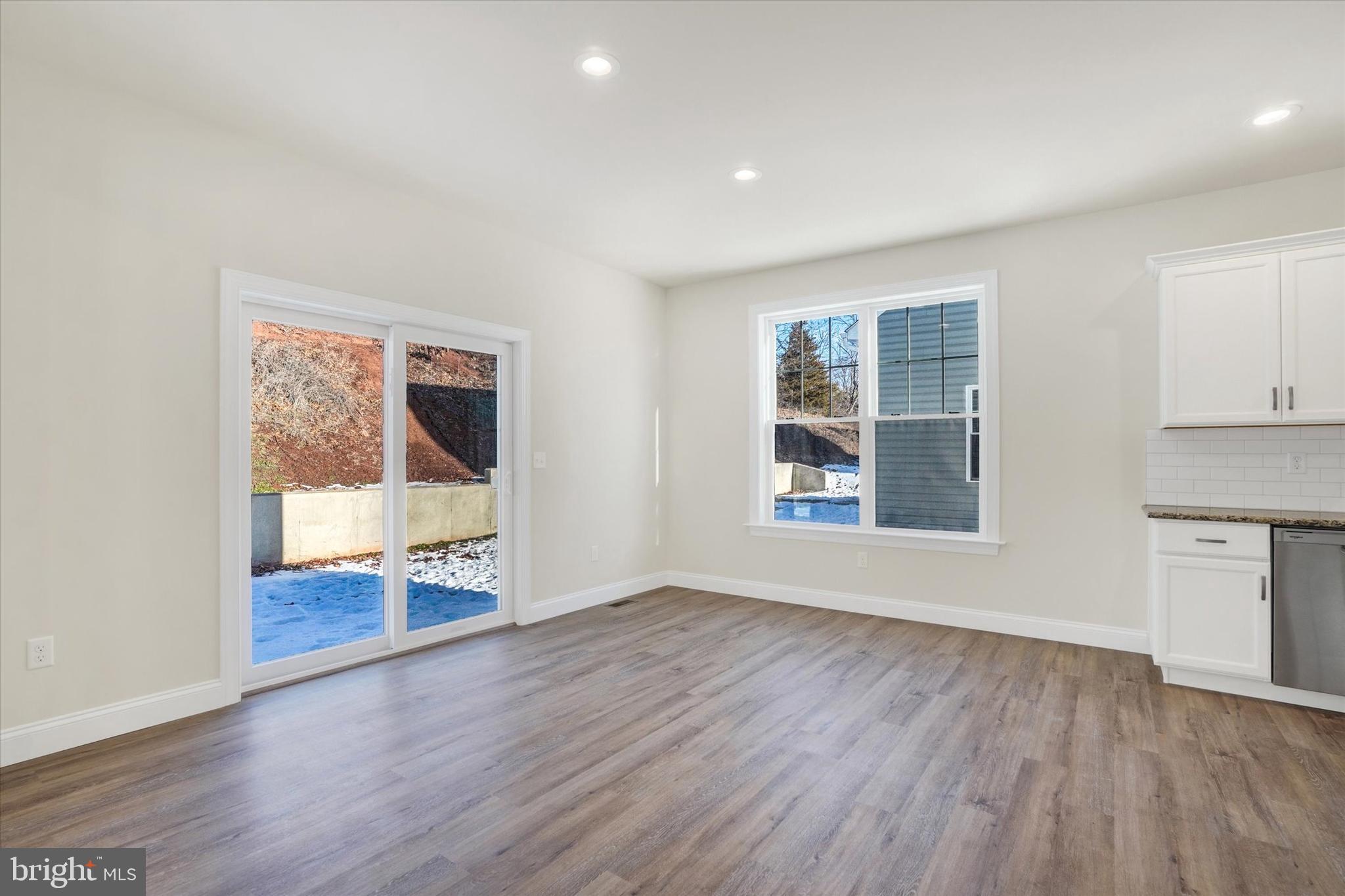 145 Eli Drive York, PA 17404 - Photo 4 of 20 an empty room with wooden floor and windows