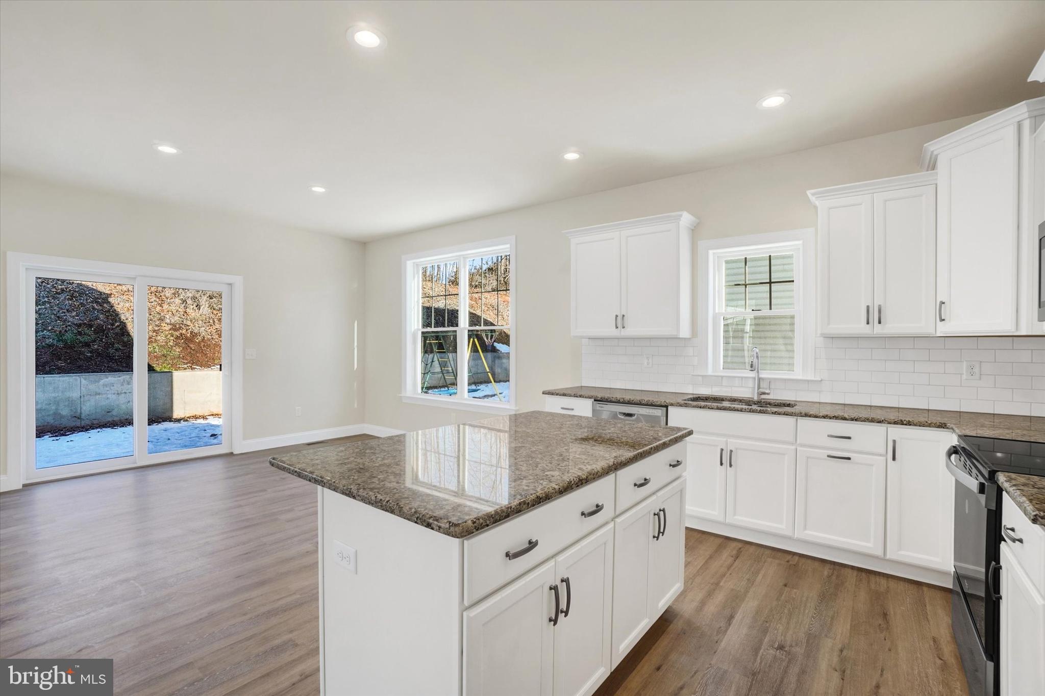 145 Eli Drive York, PA 17404 - Photo 10 of 20 a kitchen with granite countertop a sink and cabinets with wooden floor
