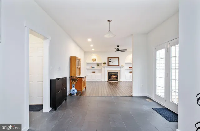 a living room with wooden floor and a fireplace