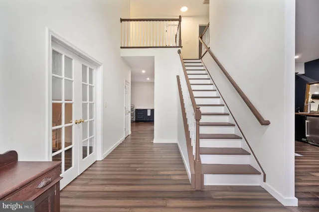 a view of a hallway with wooden floor and entryway