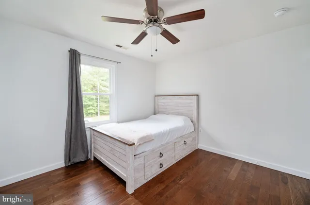 a large bedroom with a bed and a table in it