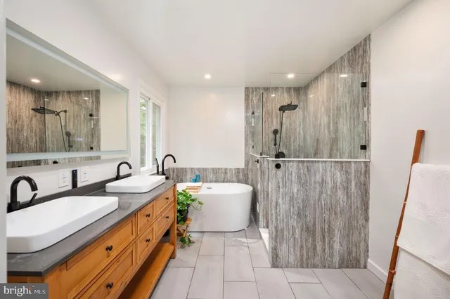 a view of a room with wooden floor and a ceiling fan