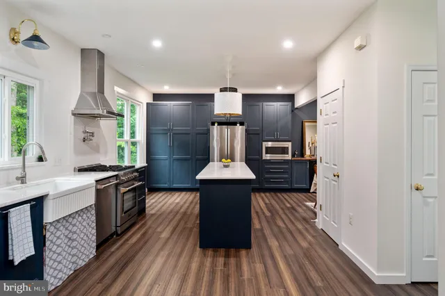 a kitchen with stainless steel appliances granite countertop a stove and a refrigerator